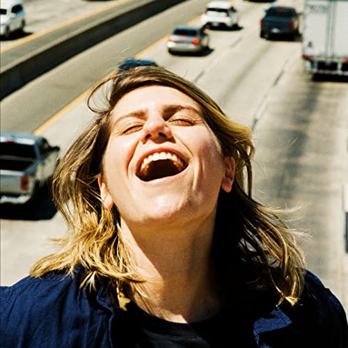 Album cover featuring a woman with blonde hair laughing with eyes closed.