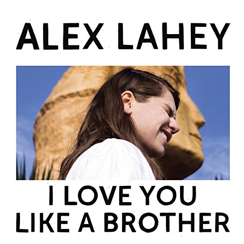 Vinyl album cover featuring a woman in front of a large stone head.