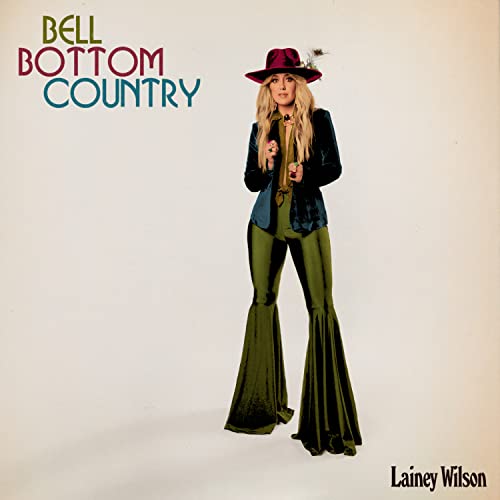 Lainey Wilson in flared green pants and a burgundy hat, album cover.