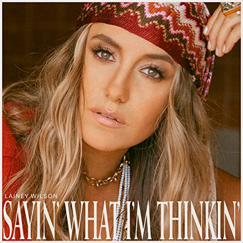 Lainey Wilson wearing a patterned headscarf and gold necklace on her album cover.