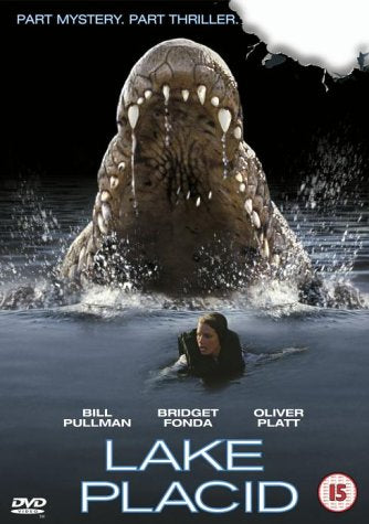 A giant crocodile emerges from water behind a woman swimming in the Lake Placid DVD.