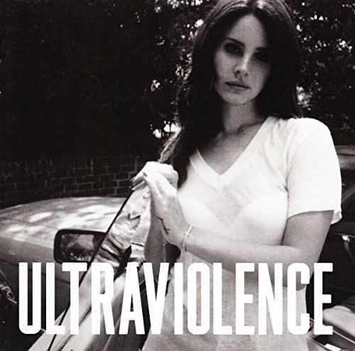 Black and white photo of Lana Del Rey standing by a car with text.