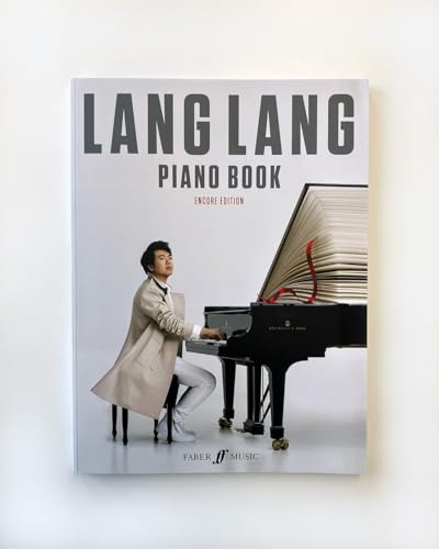 Lang Lang sits at a grand piano with a giant book open on top.
