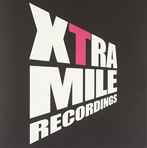 A vinyl record cover with "Xtra Mile Recordings" in white and pink text on a dark background.