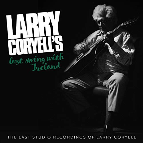 Black and white photo of Larry Coryell playing an acoustic guitar against a dark background.