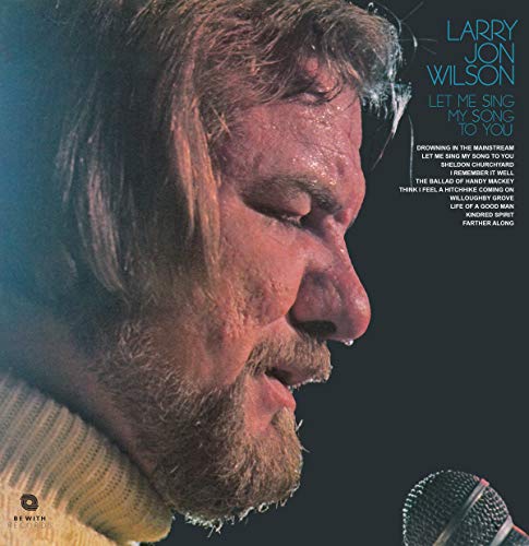 Close-up profile of Larry Jon Wilson singing into a microphone on vinyl cover.