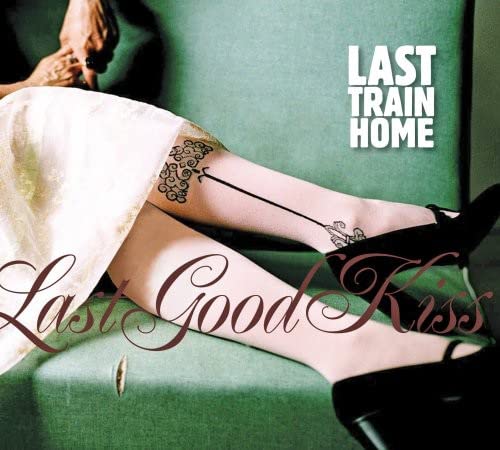 CD cover: legs in stockings, arrow tattoo, green sofa, and text.