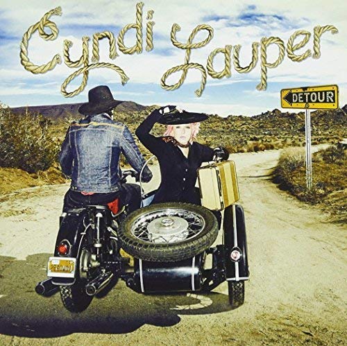 Cyndi Lauper album cover featuring a motorcycle with a sidecar in a desert.