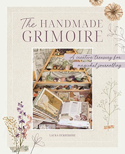Book cover with crystals, flowers, and an open journal with handwritten notes.