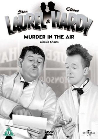 Black and white photo of Laurel and Hardy in white jackets and bow ties.