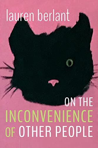 Book cover with a black cat’s face and pink and white text.
