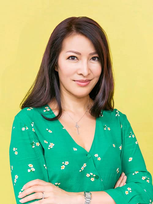 Headshot of a woman with dark hair wearing a green floral blouse.