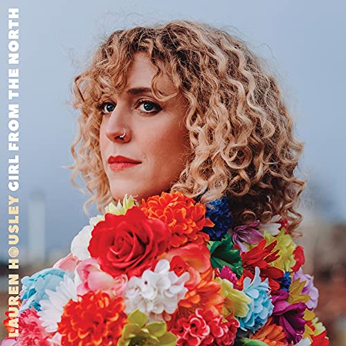Album cover featuring a woman with curly blonde hair holding colorful flowers.