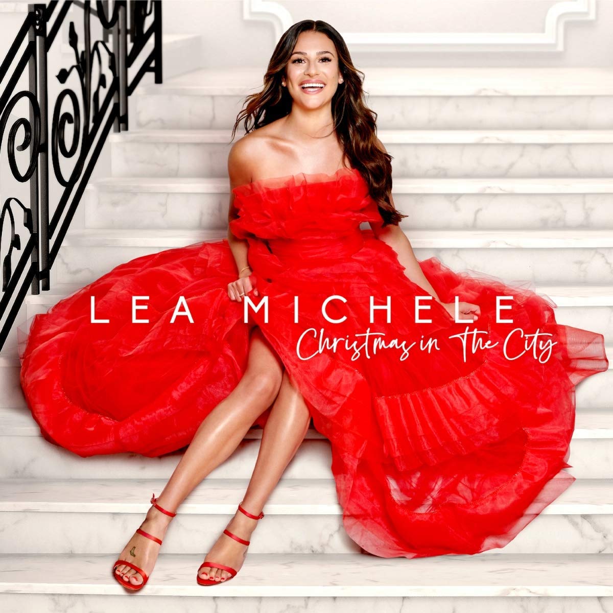 "Album cover: Lea Michele in a red dress on white marble stairs."