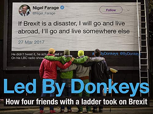 Billboard displaying a tweet with four people standing in front.