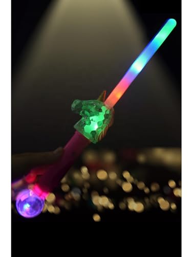 A hand holding a glowing unicorn-shaped LED wand against a dark, bokeh background.