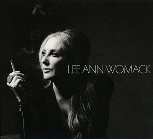 Black and white portrait of Lee Ann Womack holding a cigarette.