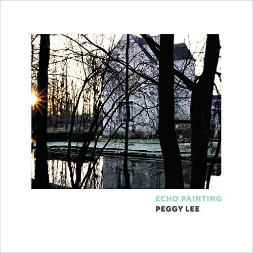 Silhouetted trees frame a building reflected in water, album text below.