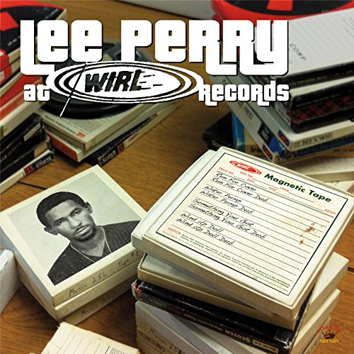 "Stacks of CDs and cassette tapes on a wooden table with 'Lee Perry' text."