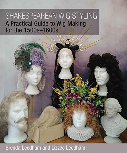 Book cover displaying historical wigs on mannequin heads with floral arrangements.