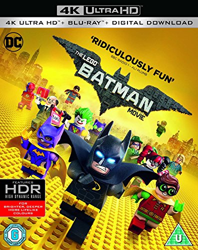 "Lego Batman figurine and friends on yellow Lego bricks with cityscape and bat-symbol."