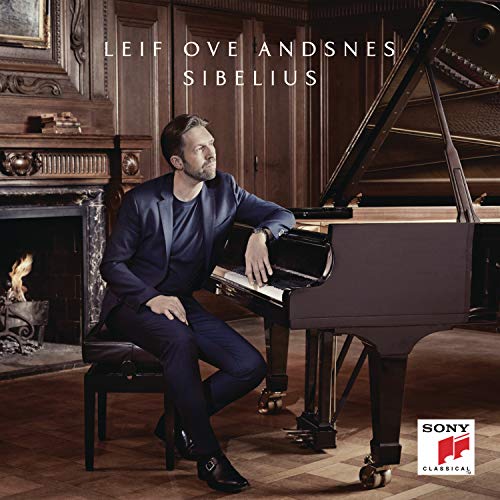 Leif Ove Andsnes sits at a grand piano in a wood-paneled room.
