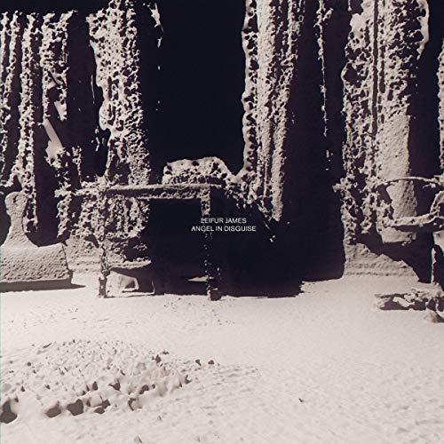 Black and white album cover with snowy rock formations and text.