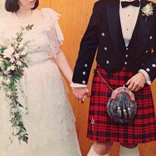 Bride in white and groom in kilt holding hands, vintage photo.