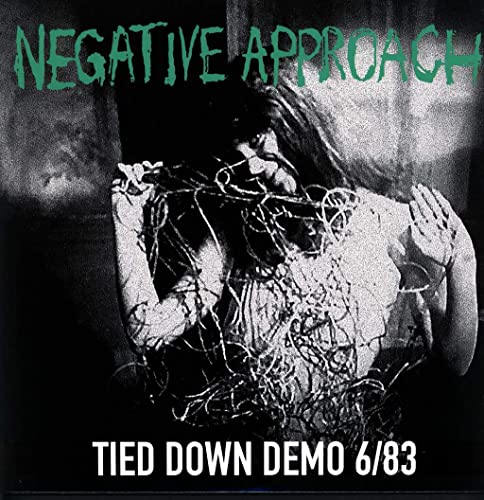 Black and white album cover showing a person tangled in wires with green text.