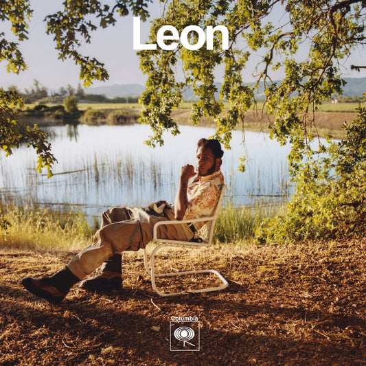Leon Bridges album cover: man seated outdoors with landscape backdrop.