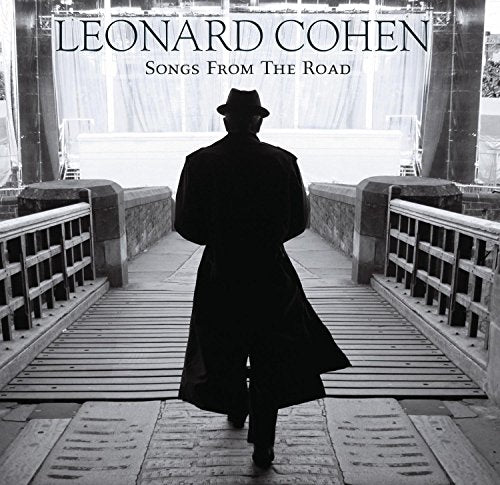 Black and white vinyl album cover featuring a man walking on a wooden bridge.