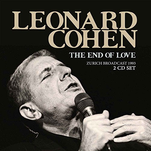 Black and white portrait of Leonard Cohen singing into a microphone.