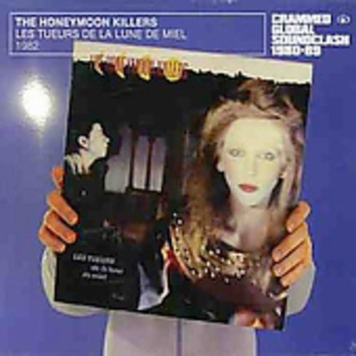 A person holds a CD album cover with a man and woman on it.