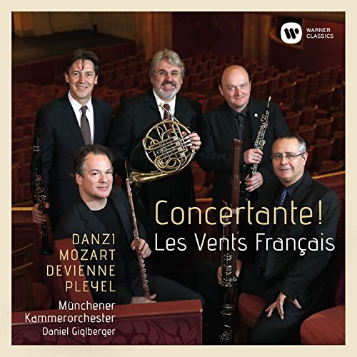Five musicians with wind instruments on a concert hall stage, "Concertante!" text overlay.