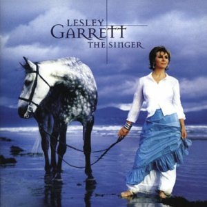 Lesley Garrett album cover with singer and dapple grey horse on beach.