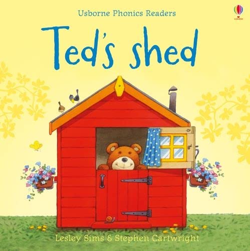 Red shed with a teddy bear peeking out of the open door.