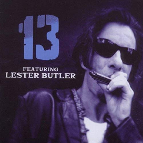 Lester Butler playing a harmonica, wearing sunglasses, with the number 13.