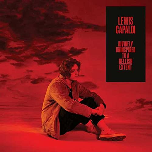 Lewis Capaldi sits on a red landscape under a red sky on this album cover.