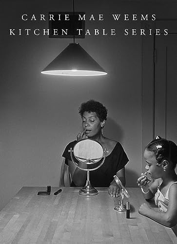 Black and white photo of two women at a kitchen table.