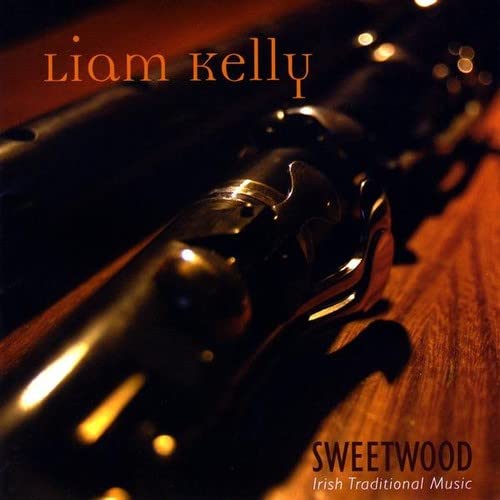 CD cover for Liam Kelly’s “Sweetwood” featuring a dark revolver.