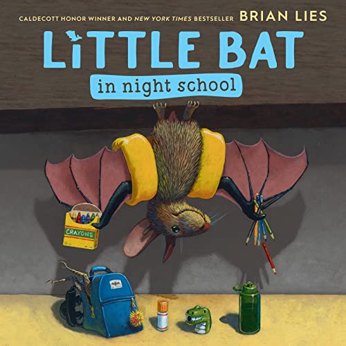 Brown bat with backpack hangs upside down near school supplies.