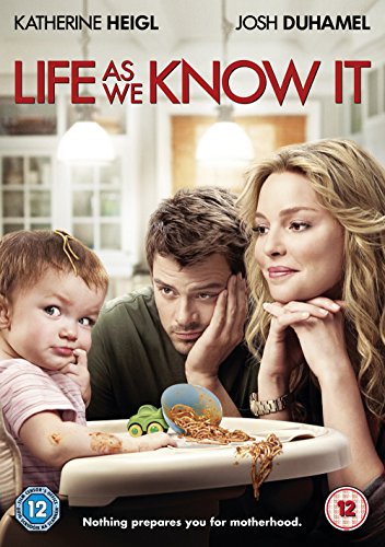 A messy family of three sit at a table with a baby in a highchair.