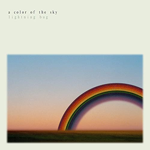 CD cover: pale sky with a blurred rainbow arc and dark horizon.