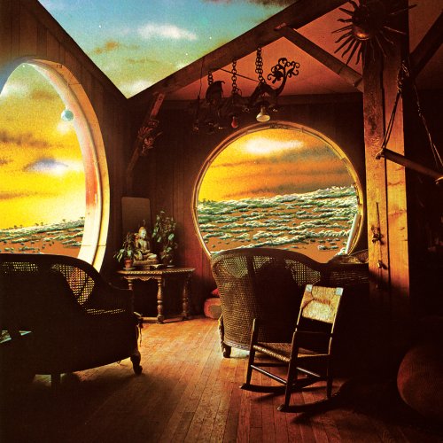 Interior room with arched windows revealing ocean and sunset views.