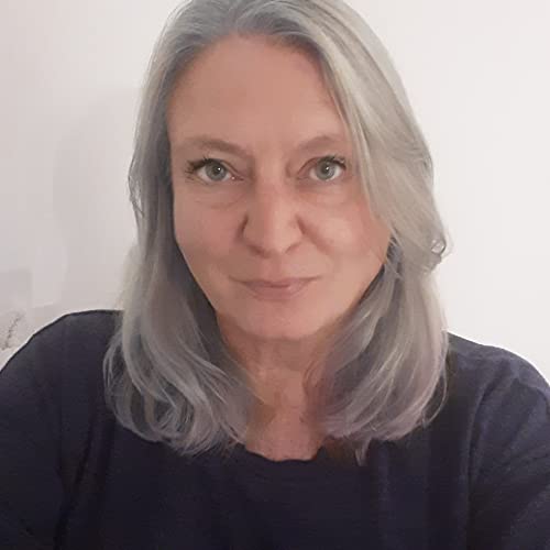 Portrait of a woman with shoulder-length grey hair wearing a dark blue shirt.