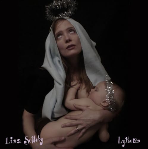 Woman with baby, both wearing crowns, in a dark, artistic portrait.