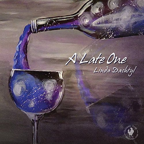 CD cover: wine pouring into a glass, purple and silver tones.