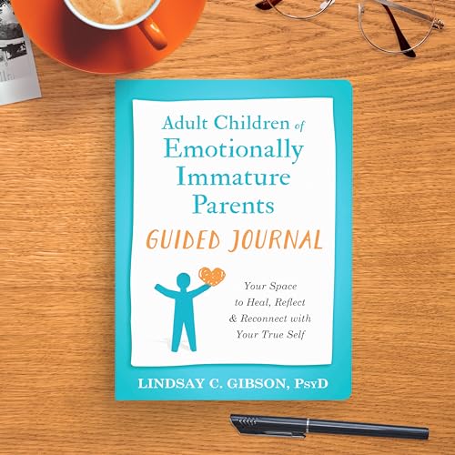 The book Adult Children of Emotionally Immature Parents Guided Journal on a wooden desk.