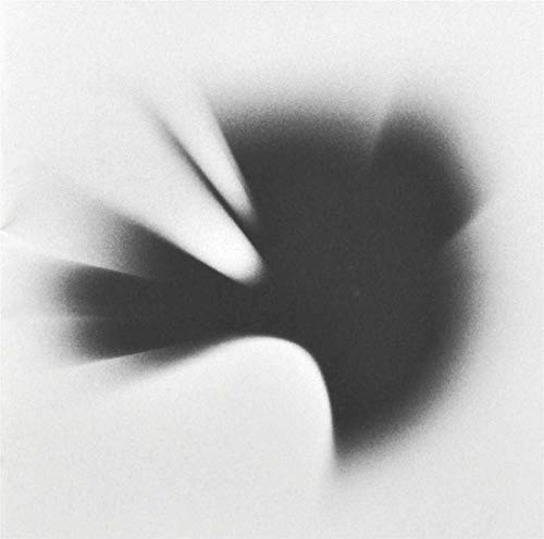 Black and white abstract image with curved shapes and blurred dark center.