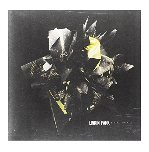 The vinyl record album cover features a black background with abstract, shattered glass-like shapes.